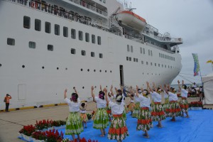 フラダンスサークル「プアコー」は豪華客船に向かって踊りを披露した＝２５日、平良港下崎ふ頭