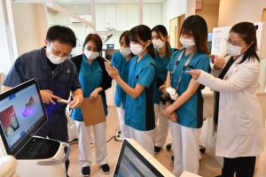 口腔内スキャナーの使用方法を学ぶ歯科衛生士らと本永院長（右）＝20日、平良東仲宗根