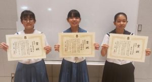 最優秀賞の友利さん（中央）、優秀賞の嘉手苅さん（右）と山下さん（左）＝10日、市未来創造センター多目的ホール