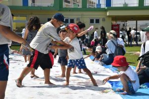 着ているＴシャツにも塗りあう子どもたち＝24日、パイナガマ海空すこやか公園