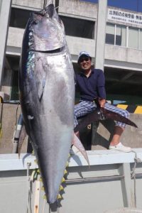 ２年連続で大物クロマグロを釣り上げた観光客の男性＝５日、荷川取漁港（提供写真）
