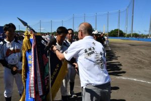 優勝旗を受け取る宮古島アララガマボーイズのメンバー＝21日、伊良部球場