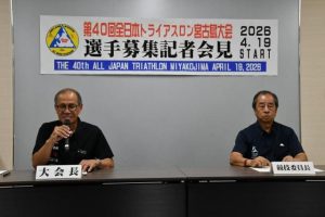会見で応募を呼び掛ける嘉数市長（左）と砂川恵助競技委員長＝９月30日、市役所