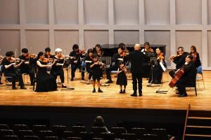 国内演奏家と子供たちが演奏を披露した。指揮は天野誠さん＝８月31日、マティダ市民劇場