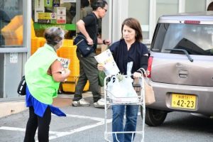 市民に交通安全のチラシを配布するメンバー＝30日、サンエーショッピングタウン宮古食品館