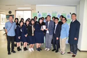 野津委員長（前列右から４人目）が砂川部長に寄付金を手渡した＝25日、宮古高校